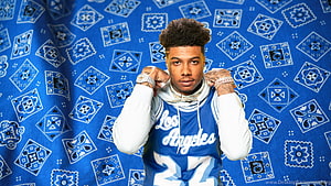 Blueface in a Los Angeles jersey against a blue patterned backdrop HD wallpaper