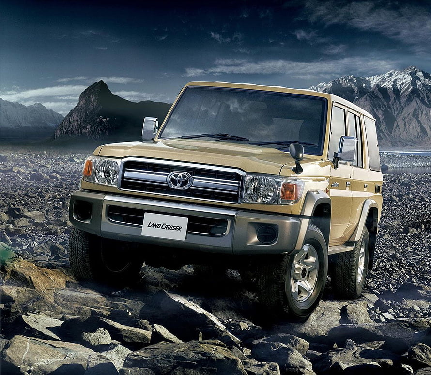 Gold Toyota Land Cruiser 70 Series on Rocky Mountain Terrain HD wallpaper
