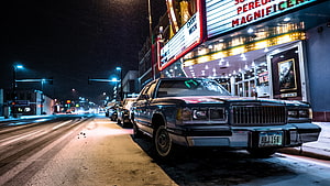 Vintage Lincoln Continental Parked on Snowy City Street at Night HD wallpaper