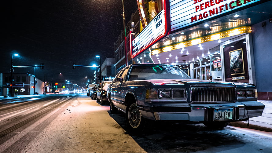 Vintage Lincoln Continental Parked on Snowy City Street at Night HD wallpaper