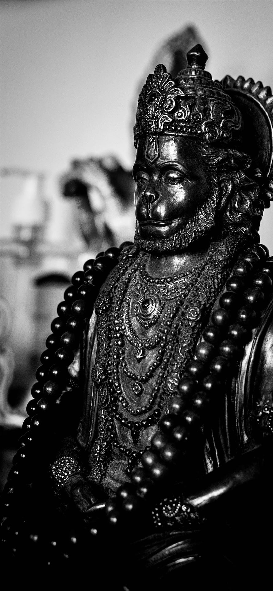 Black and White Krishna Statue with Ornate Crown and Beaded Garlands HD phone wallpaper
