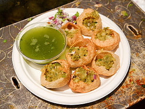 Traditional Indian Pani Puri with Spiced Potato Filling and Green Chutney HD wallpaper