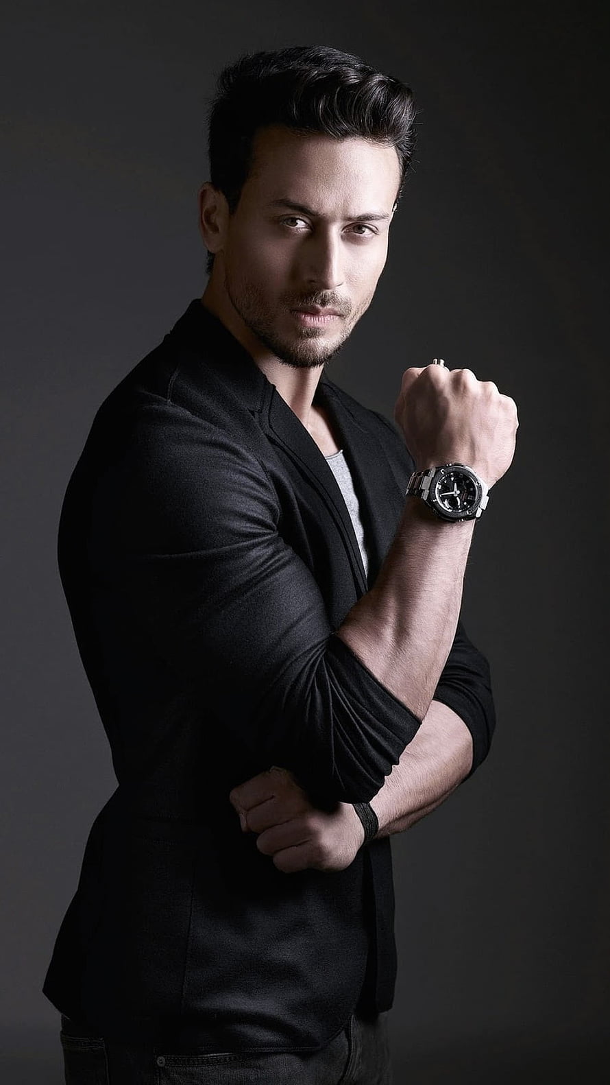 Tiger Shroff in Black Blazer with Wristwatch Against Dark Studio Background HD phone wallpaper