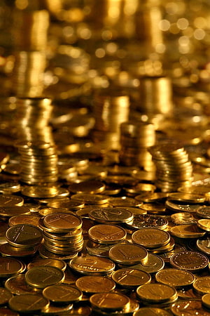 Stacks of Golden Coins and Currency in a Warm, Glowing Financial Scene HD phone wallpaper