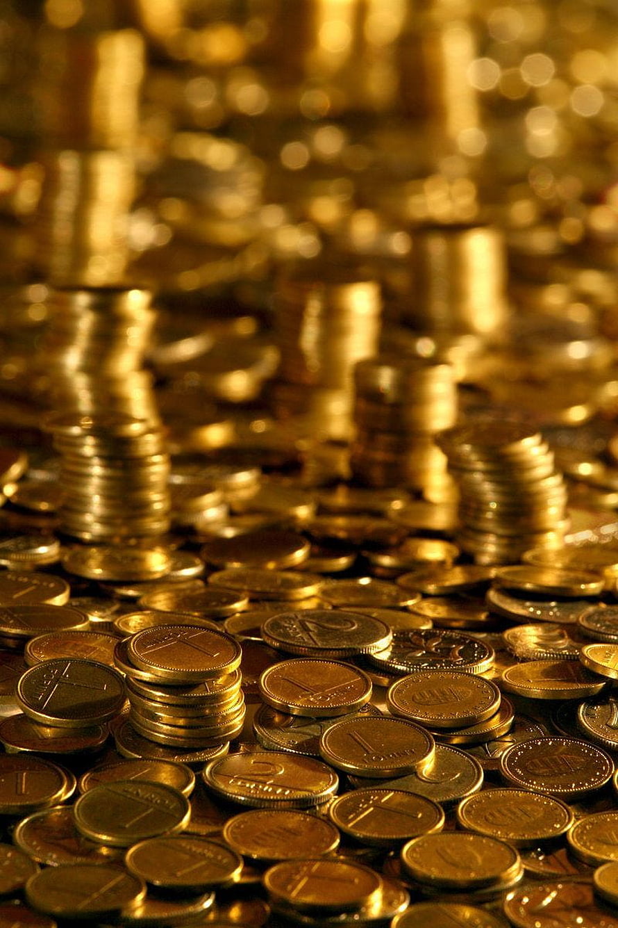 Stacks of Golden Coins and Currency in a Warm, Glowing Financial Scene HD phone wallpaper