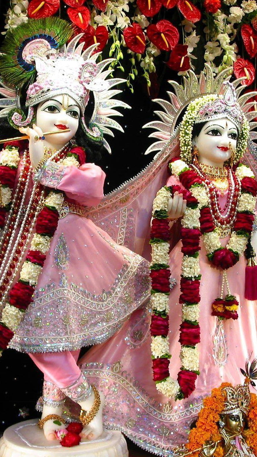 Radha Krishna Temple Idol in Pink Attire with Floral Garlands and Ornate Headdresses HD phone wallpaper