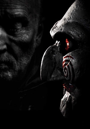 Jigsaw Mask with Glowing Red Eye and Spiral Mark in Dark Horror Scene HD phone wallpaper