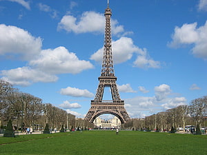 Eiffel Tower in Paris France with Green Lawn and Blue Sky HD wallpaper