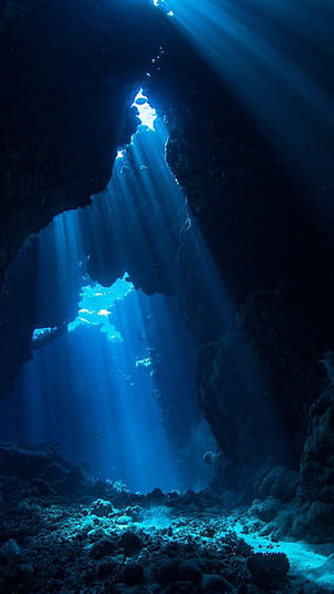 Sunbeams Piercing Through an Underwater Cave Opening HD phone wallpaper