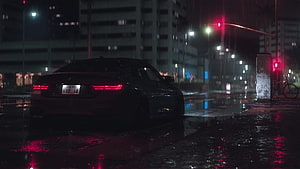 BMW M4 Sedan Parked on Wet City Street at Night with Red Traffic Lights HD wallpaper