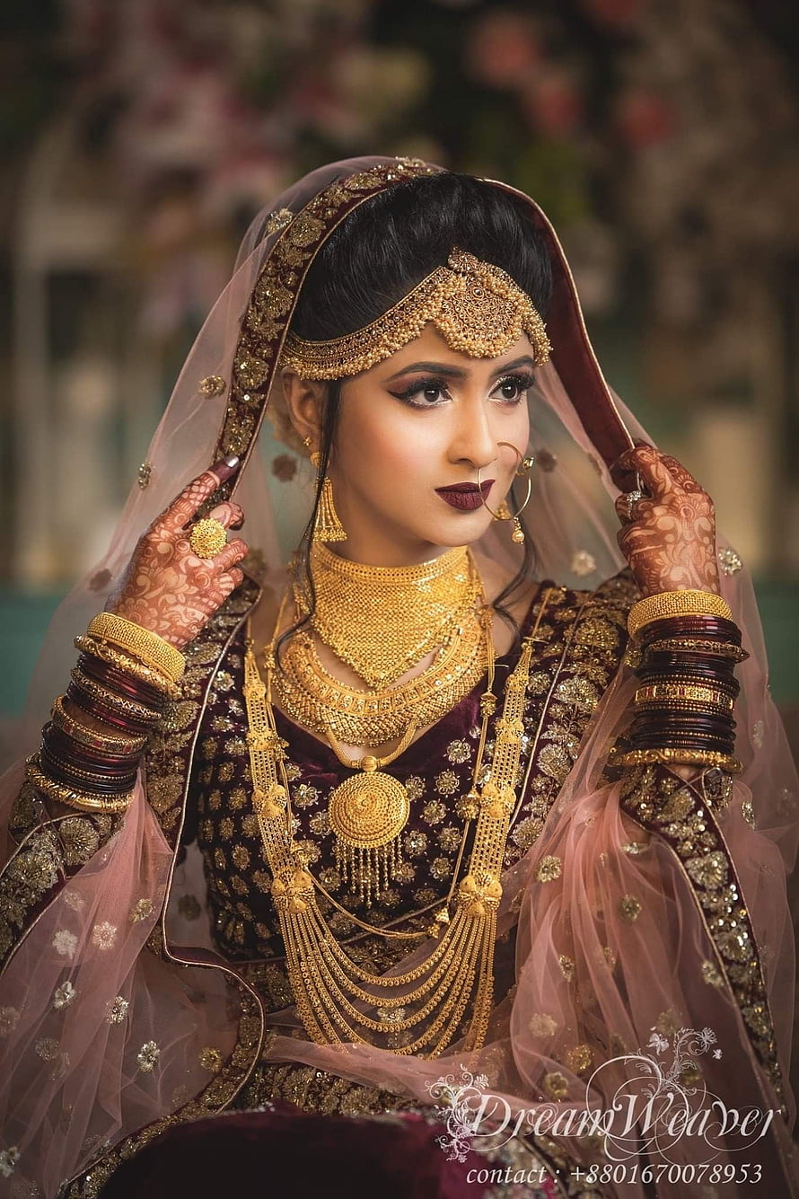 Elegant South Asian Bride in Traditional Maroon and Gold Bridal Attire with Intricate Jewelry HD phone wallpaper