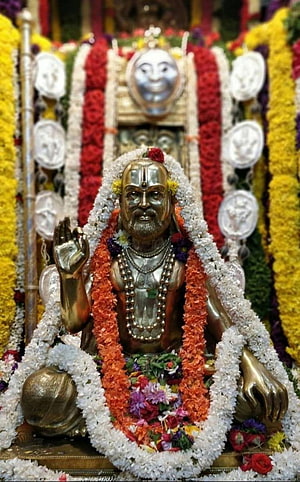 Raghavendra Swamy Temple Idol Adorned With Vibrant Flower Garlands And Traditional Decorations HD phone wallpaper