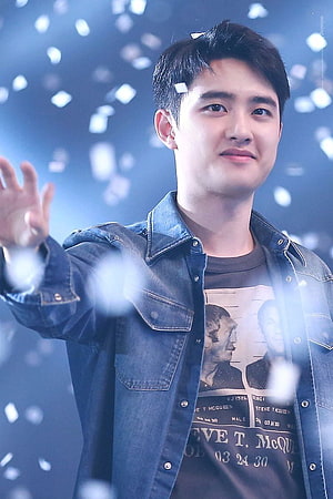 D.O. from EXO Waving at Fans in Denim Jacket Under Blue Stage Lights HD phone wallpaper