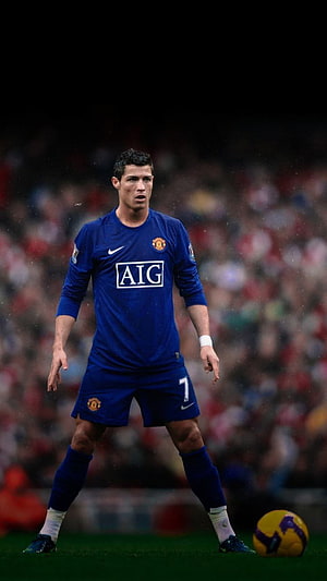 Cristiano Ronaldo in Manchester United Blue Away Kit with AIG Sponsor on the Pitch HD phone wallpaper