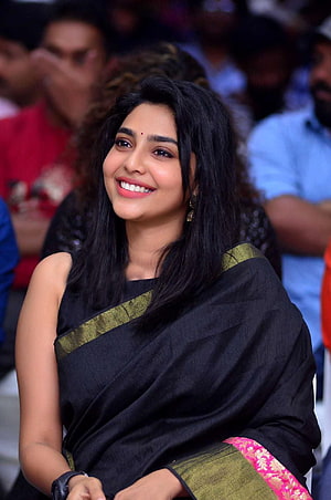 Aishwarya Lekshmi in a Black Saree with Gold Border at a Public Event HD phone wallpaper