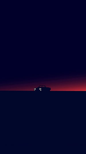 Minimalist car silhouette against a dark twilight horizon with a red glow HD phone wallpaper