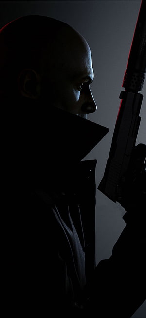 Hitman Agent 47 Profile Silhouette with Suppressed Pistol in Dramatic Low-Key Lighting HD phone wallpaper