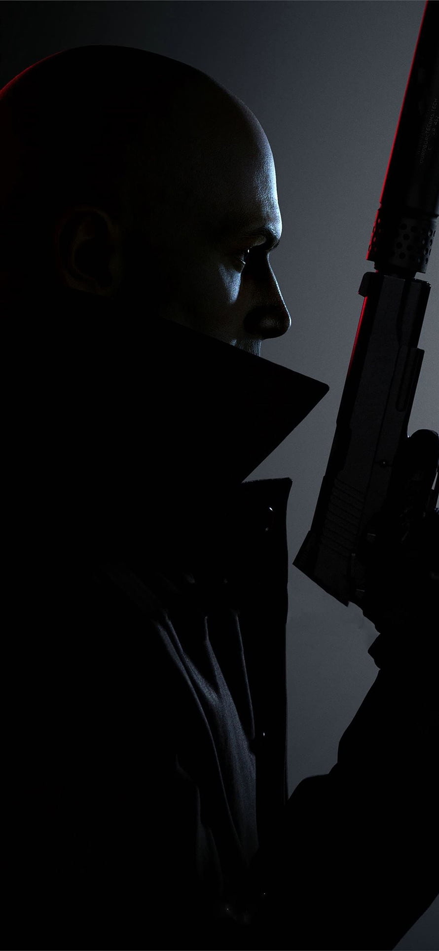 Hitman Agent 47 Profile Silhouette with Suppressed Pistol in Dramatic Low-Key Lighting HD phone wallpaper