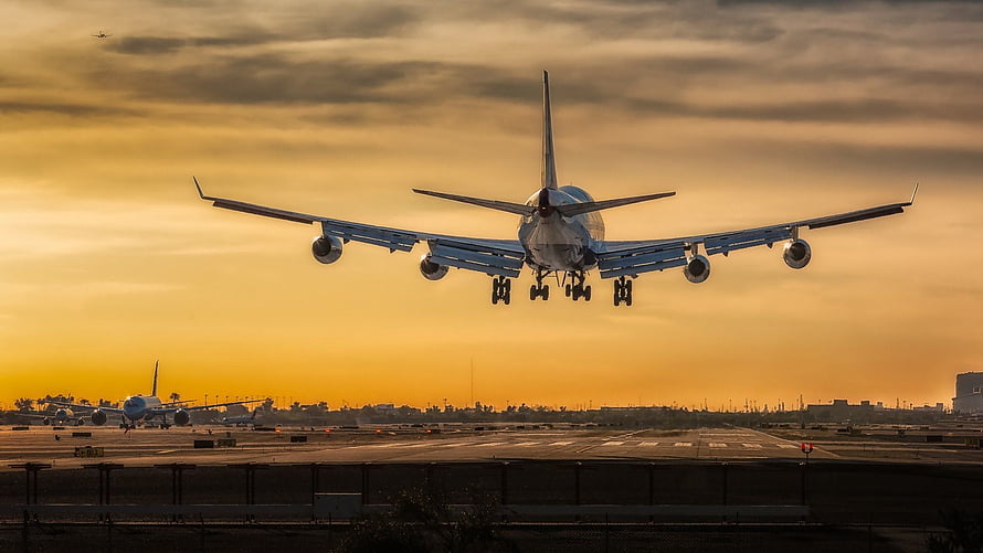 Boeing 747 Jumbo Jet Taking Off at Golden Hour Over Airport Runway HD wallpaper