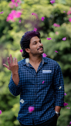 Allu Arjun in Ala Vaikuntapurram Lo with falling pink petals and green foliage HD phone wallpaper