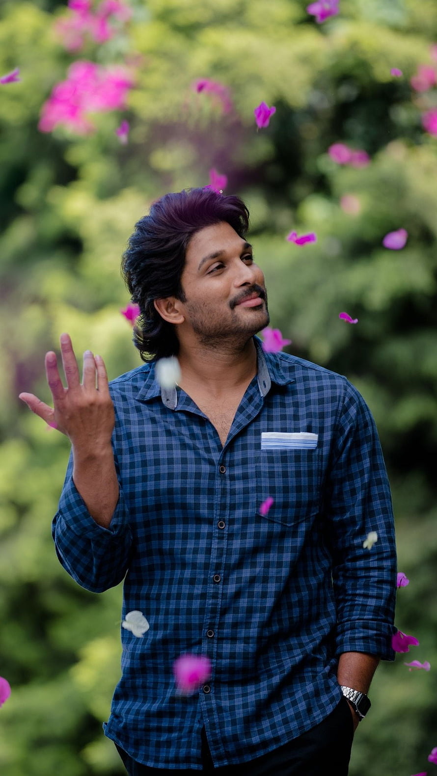 Allu Arjun in Ala Vaikuntapurram Lo with falling pink petals and green foliage HD phone wallpaper