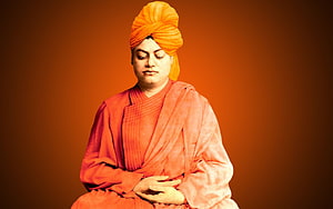 Swami Vivekananda in traditional orange robes and turban with eyes closed in meditation HD wallpaper