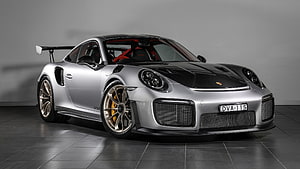 Silver Porsche 911 GT3 RS with black carbon hood and rear wing in studio HD wallpaper