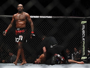 Jon Jones Standing in UFC Octagon After Knockout Victory HD wallpaper