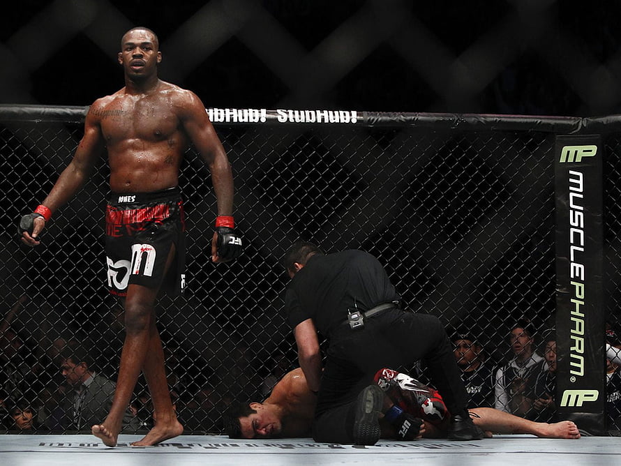 Jon Jones Standing in UFC Octagon After Knockout Victory HD wallpaper