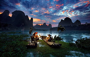 Cormorant Fishermen on Bamboo Rafts in the Li River at Sunset HD wallpaper