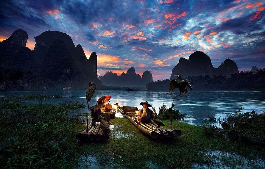 Cormorant Fishermen on Bamboo Rafts in the Li River at Sunset HD wallpaper