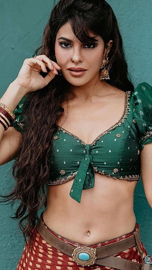 Jacqueline Fernandez in Green Embroidered Choli and Red Patterned Skirt HD phone wallpaper