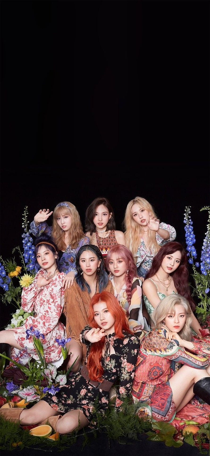 TWICE Group Portrait in Floral Outfits Surrounded by Vibrant Garden Flowers HD phone wallpaper