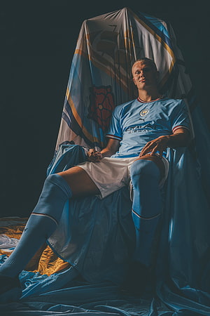 Erling Haaland in Manchester City Kit Seated on Throne with Draped Fabric HD phone wallpaper