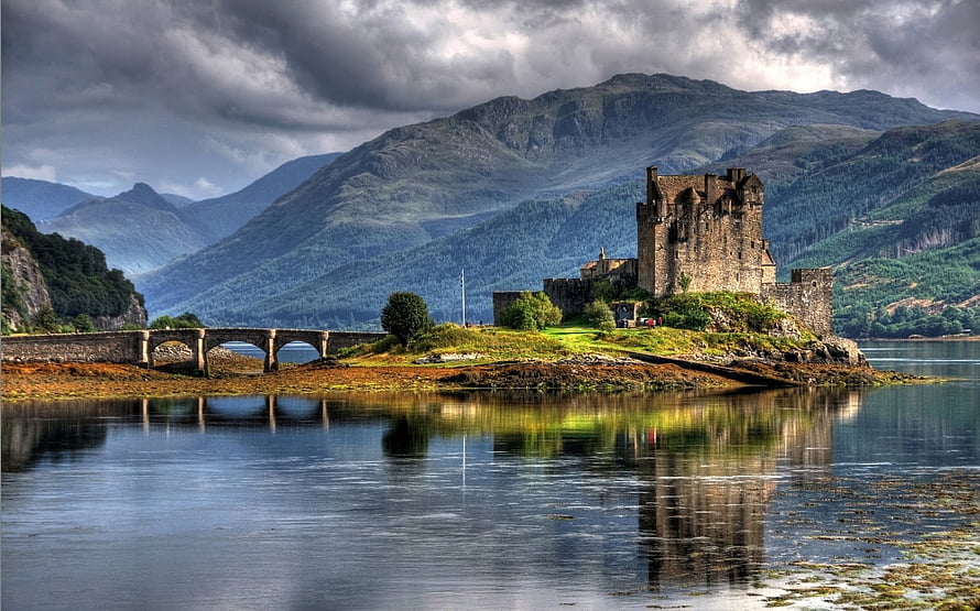 Eilean Donan Castle on a Scottish Highland Loch with Mountain Backdrop HD wallpaper