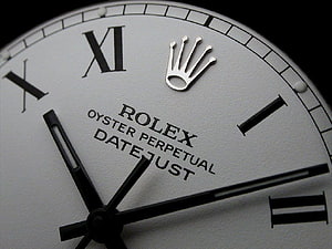 Close-Up of a Rolex Oyster Perpetual Datejust Watch Face with Roman Numerals and Crown Logo HD wallpaper