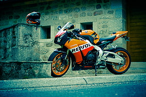 Orange Honda CBR Fireblade Repsol Motorcycle Parked Against Stone Wall HD wallpaper
