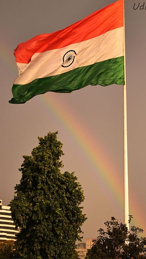 Indian National Flag Waving in the Wind with a Vibrant Rainbow Arcing Across the Sky HD phone wallpaper