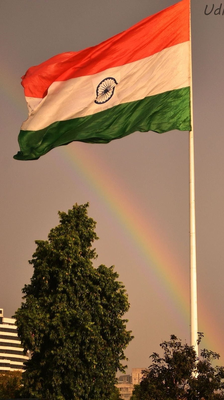 Indian National Flag Waving in the Wind with a Vibrant Rainbow Arcing Across the Sky HD phone wallpaper