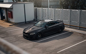 Matte Black BMW M4 F82 Coupe Parked in Urban Lot HD wallpaper