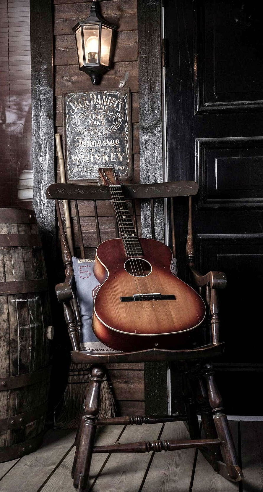 Vintage Acoustic Guitar Resting on a Rustic Wooden Rocking Chair in a Country Porch Setting HD phone wallpaper
