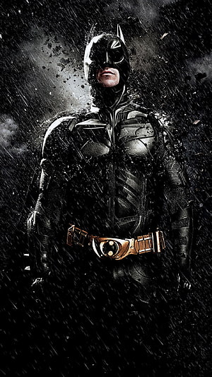Batman in Dark Knight Rises Suit Standing in Heavy Rain with Dramatic Lighting HD phone wallpaper