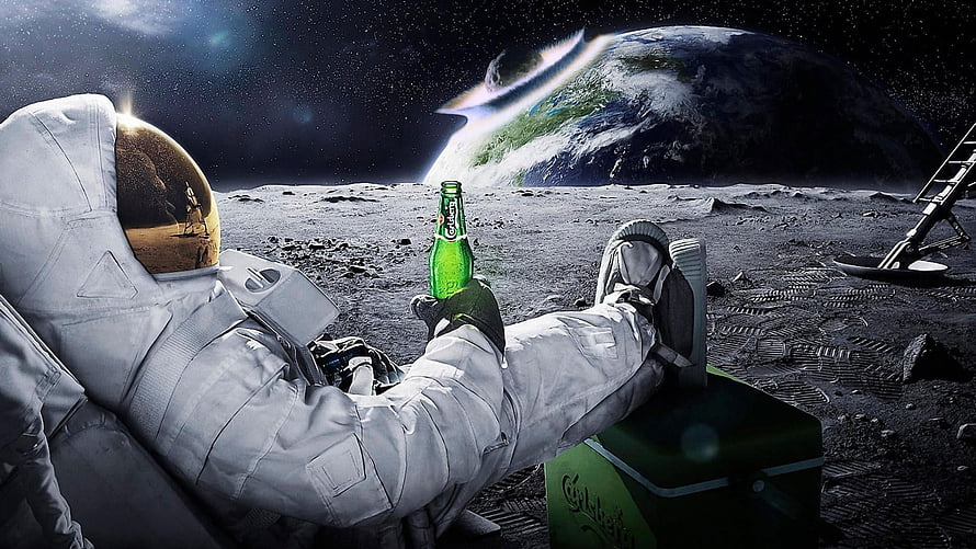 Astronaut Relaxing on the Lunar Surface with a Green Beer Bottle and Earth in the Distance HD wallpaper