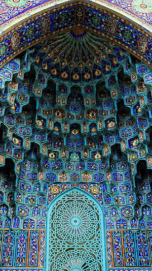 Intricate Blue Tilework and Muqarnas Vaulting in Islamic Architecture HD phone wallpaper
