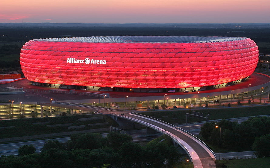 Allianz Arena Stadium in Munich Glowing Red at Dusk with Aerial View HD wallpaper