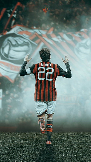 Kaka in AC Milan Striped Kit Celebrating on the Pitch with Stadium Banners in Background HD phone wallpaper