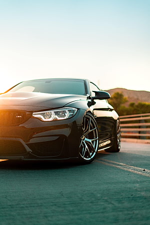 Black BMW M4 Coupe Low Angle Front View at Golden Hour HD phone wallpaper