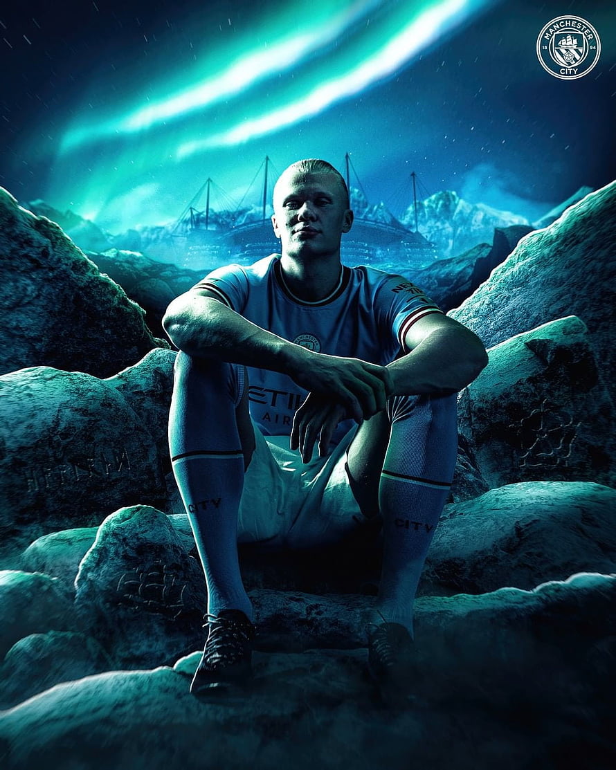 Erling Haaland in Manchester City Kit Seated on Rocks Under Aurora Sky HD phone wallpaper