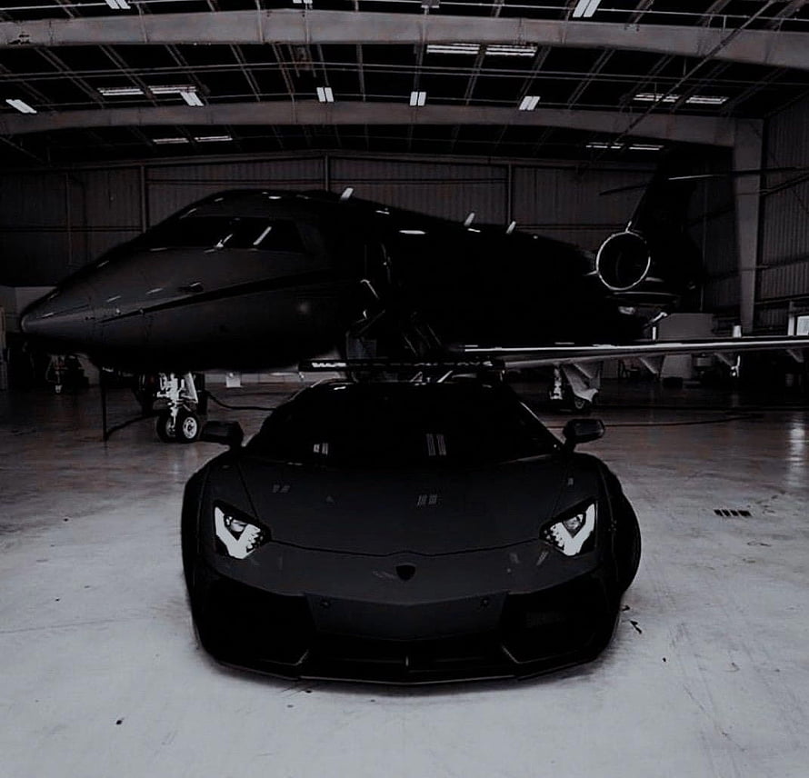 Black Lamborghini Aventador and Private Jet in Hangar HD wallpaper
