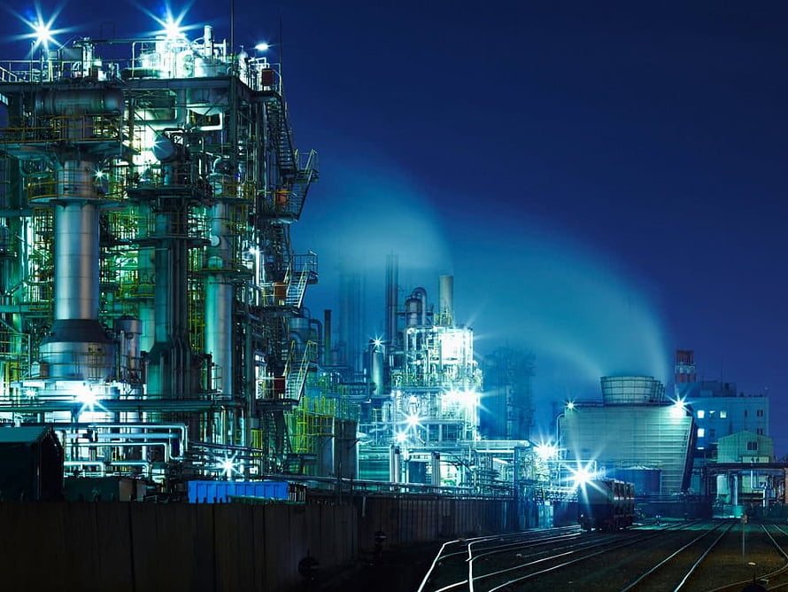 Illuminated Chemical Plant at Night with Industrial Refinery Structures and Steam HD wallpaper